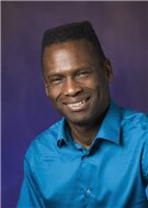 Head shot of professor Philip Phillips on a blue background