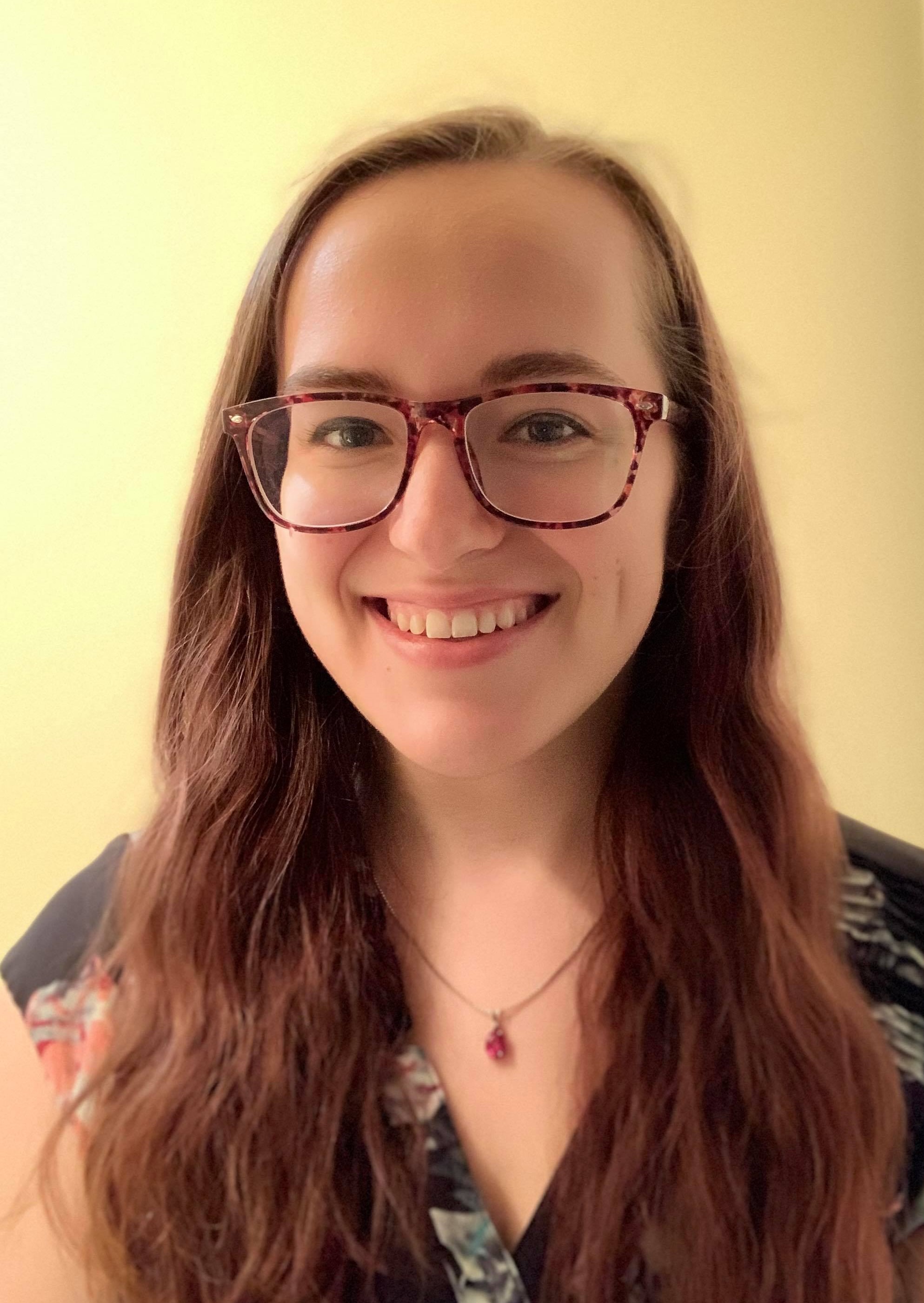 Head shot of Mara Paterson on a tan background