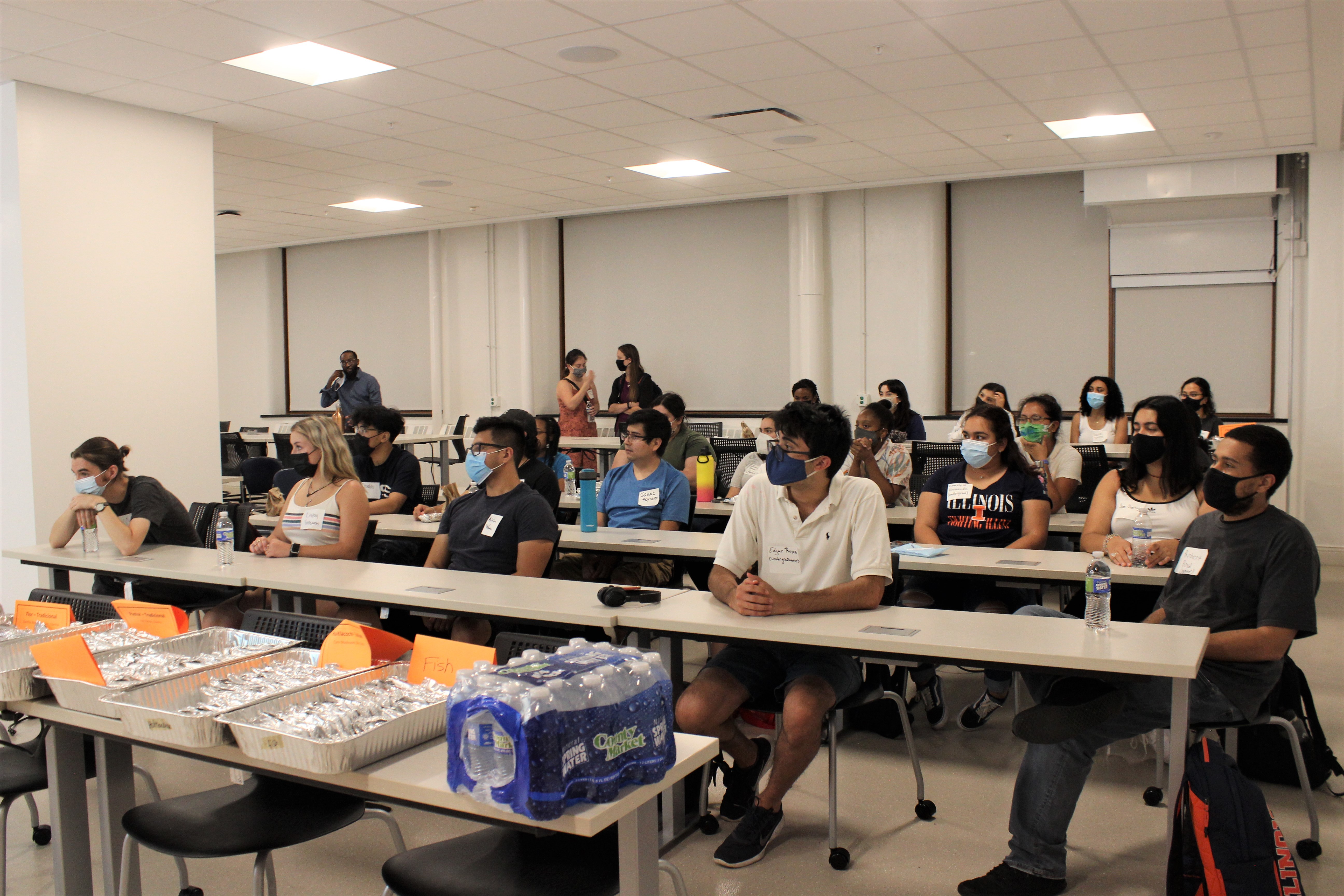 Students sit at desks in a classroom in Noyes Laboratory listening to a presentation by Lisa Olshansky.