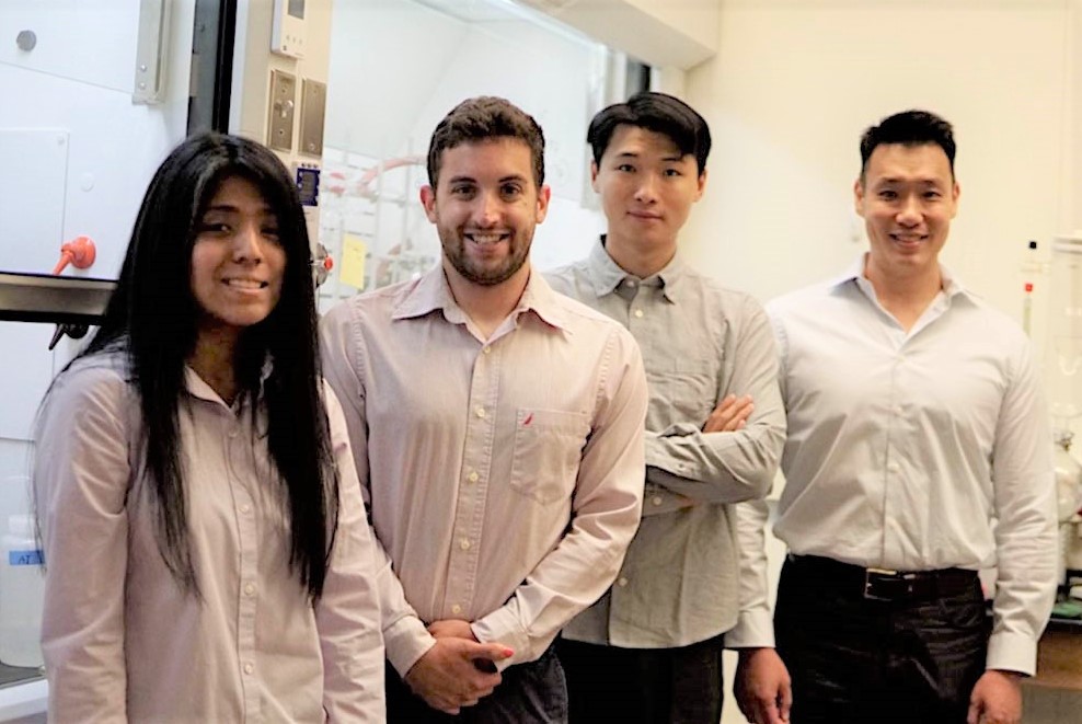 Environmental shot of the researchers in the lab, standing side by side.