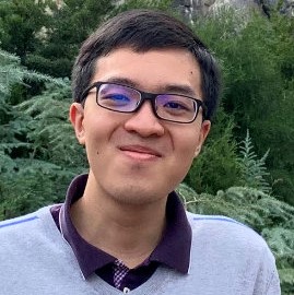 Head shot of Aymen Roslend in front of an evergreen tree