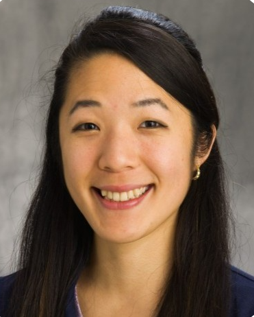 Head shot of Aya Kelly on a grey background