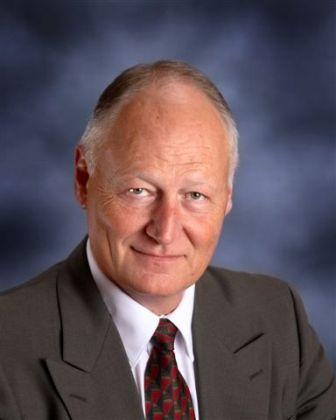 Head shot of Terry Balthazor on a blue background