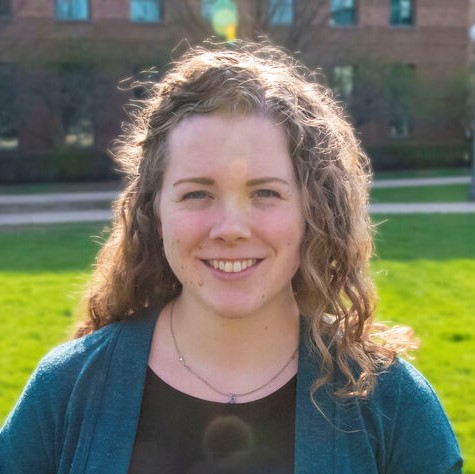 Head shot of Kelly Powderly outdoors with grass and a building in the background