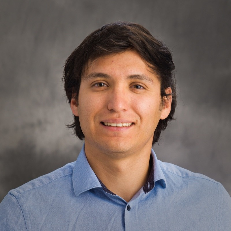 Head shot of Leonel Griego on a gray background