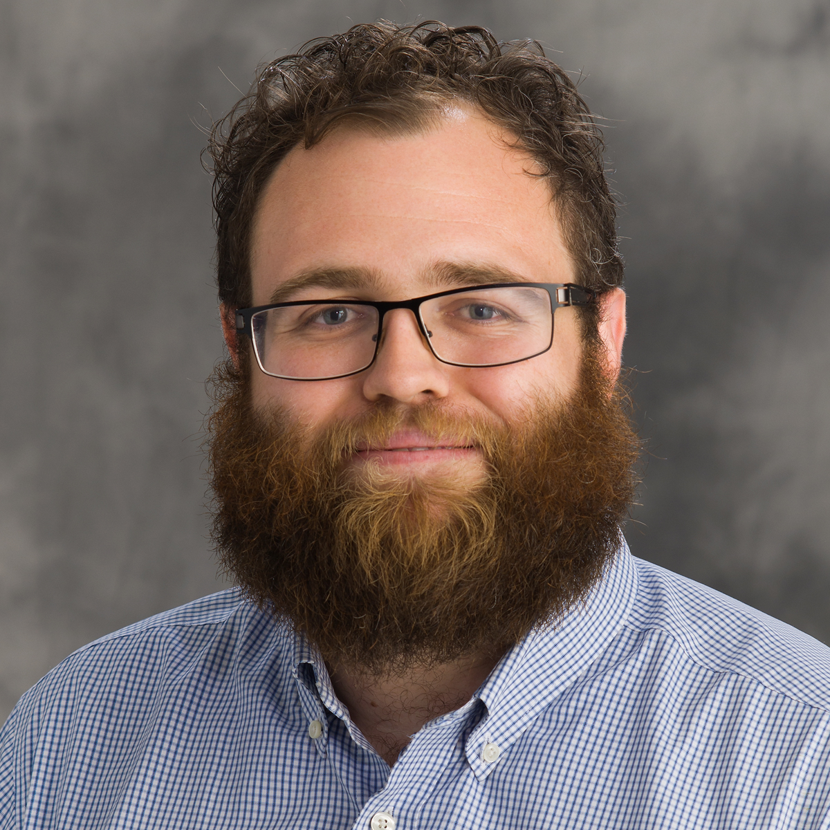 Head shot of John Leveritt on a gray background