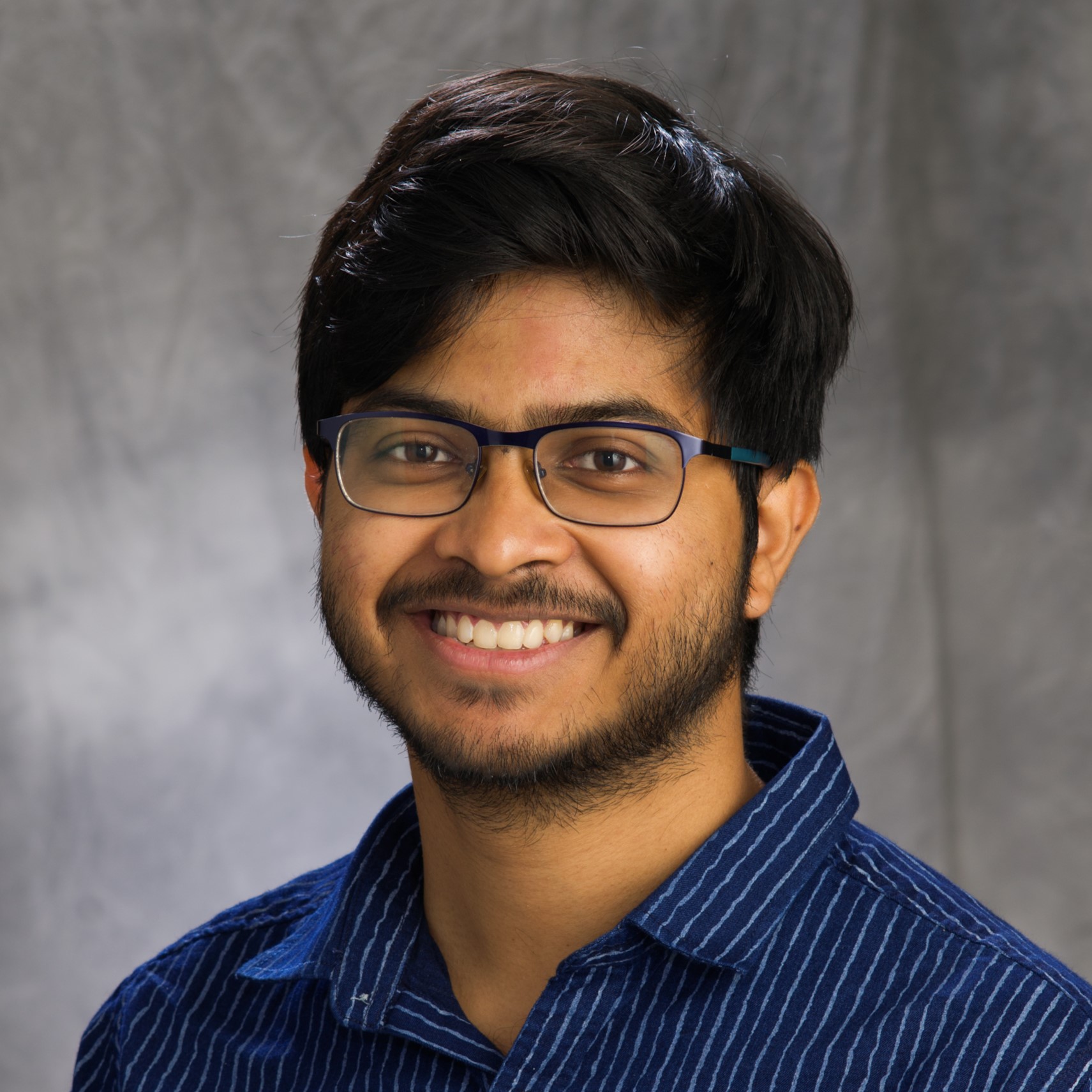 Head shot of Shounak Nath on a gray background