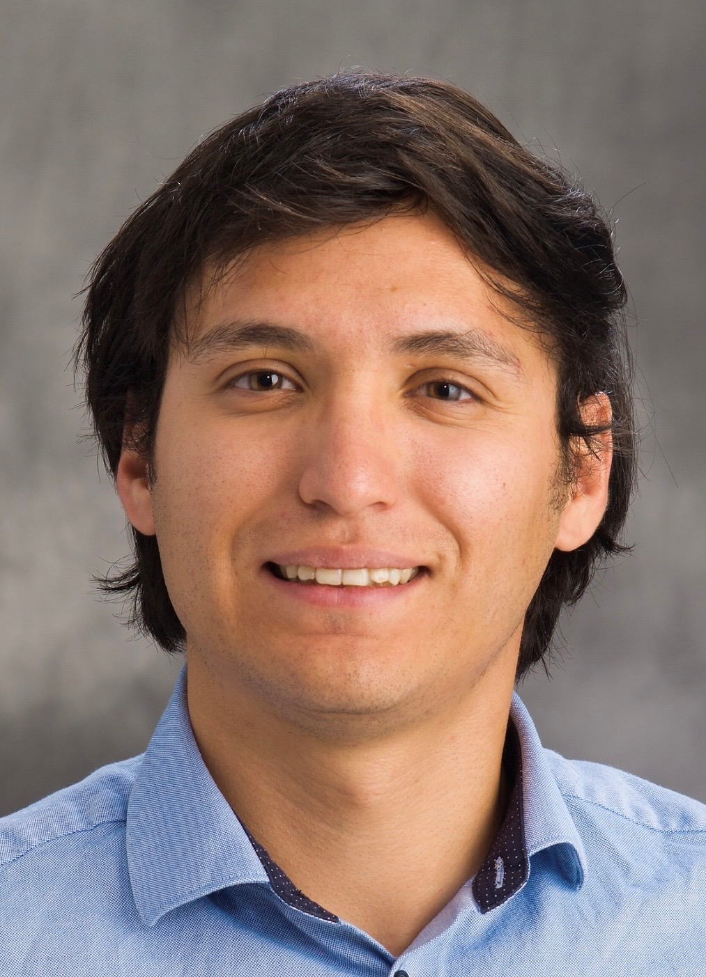 Head shot of Leonel Griego on a gray background