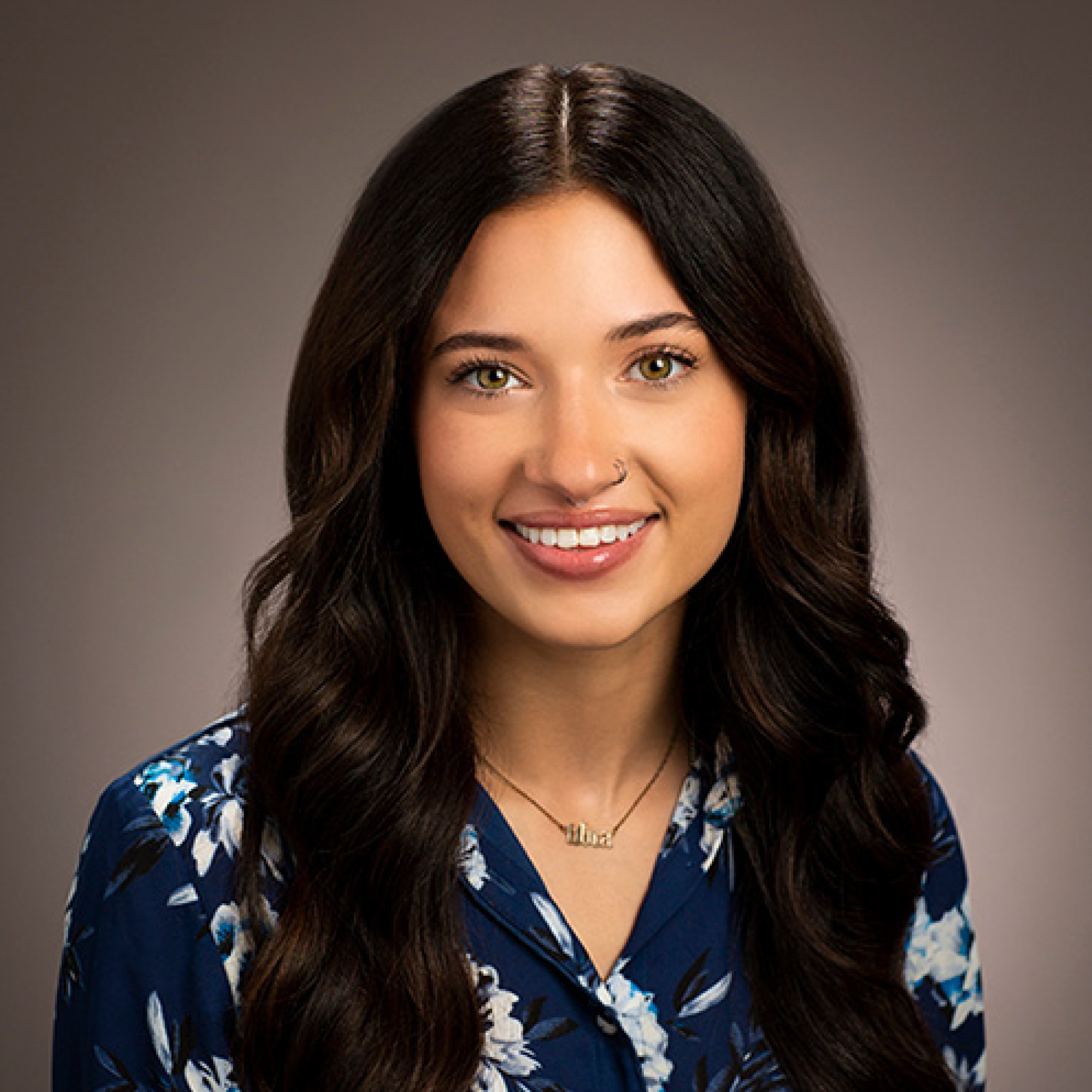 Head shot of Amie Baumeister on a tan background