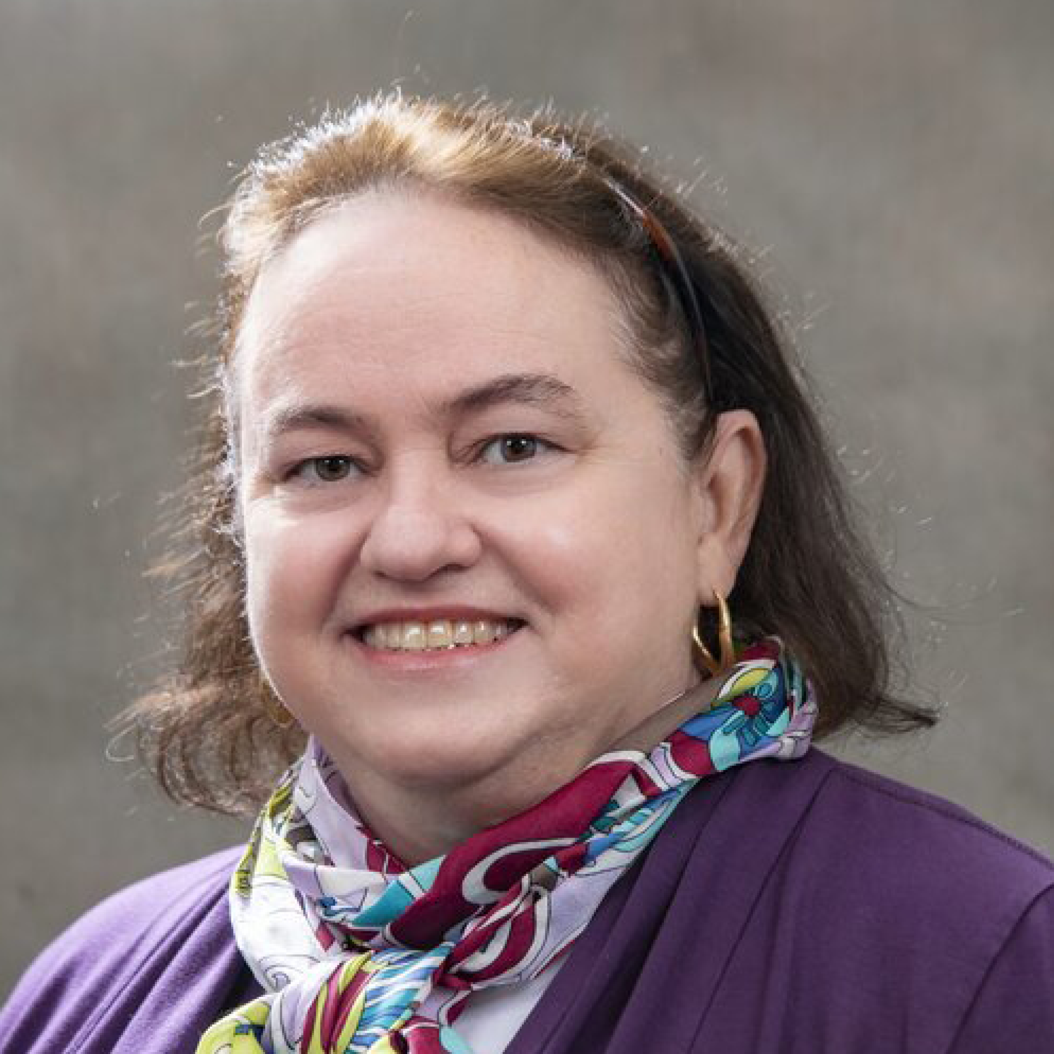 Head shot of Brenda Wilson on a tan background