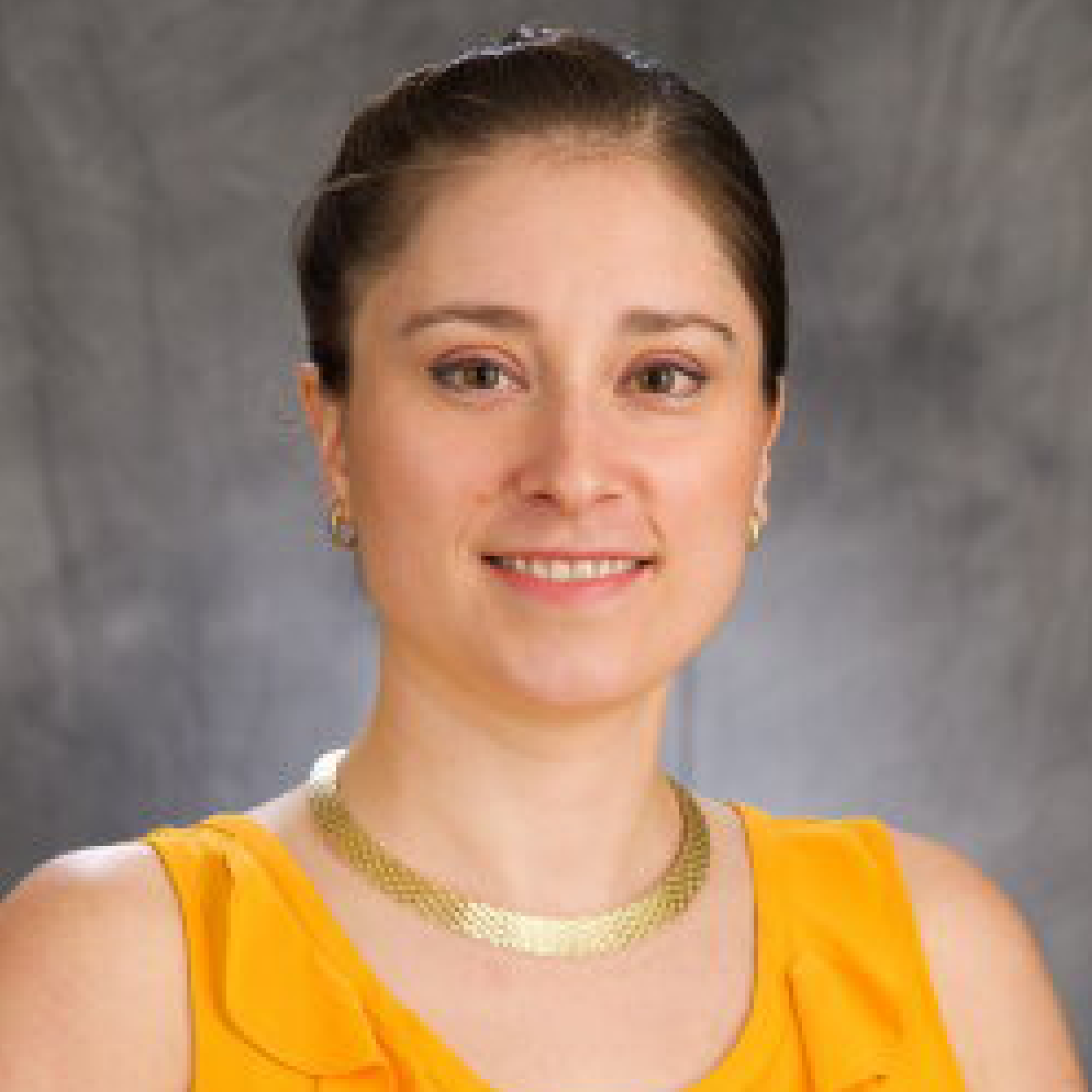 Head shot of Jordan Axelson on a gray background