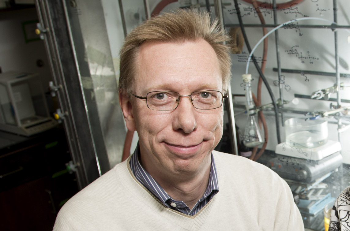 Head shot of Wilfred van der Donk in a lab in front of equipment