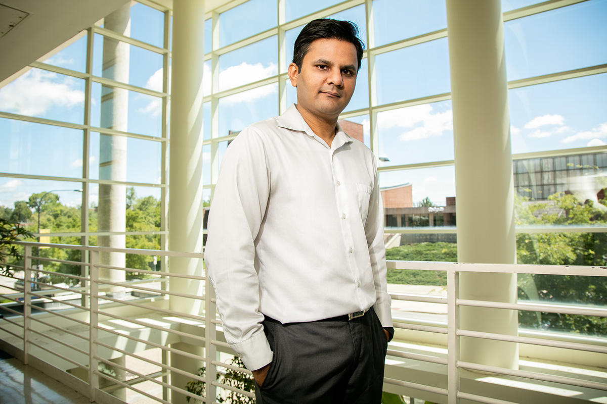 Portrait of Prashant Jain with windows behind him