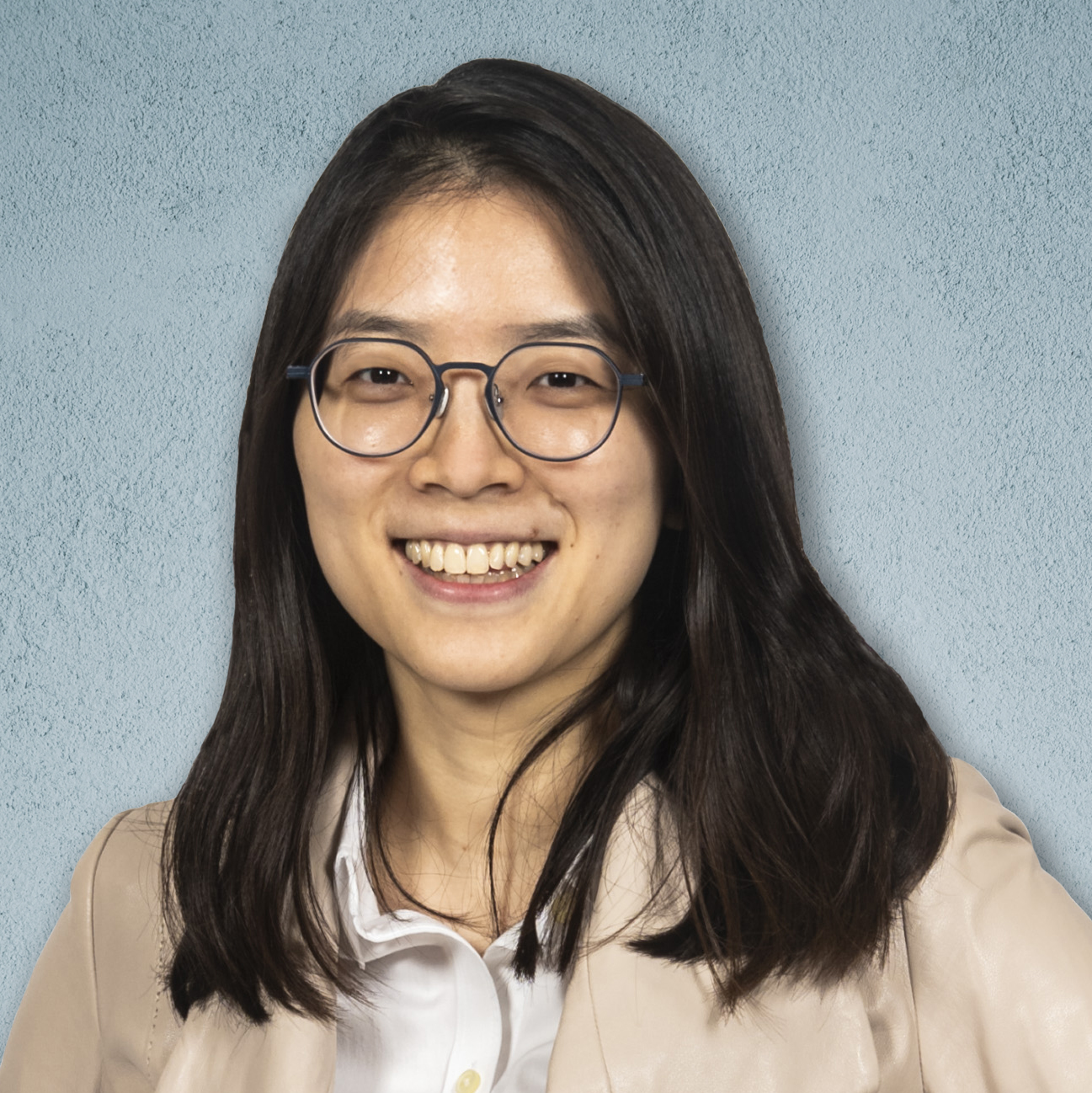 Head shot of Hee-Sun Han, blue background