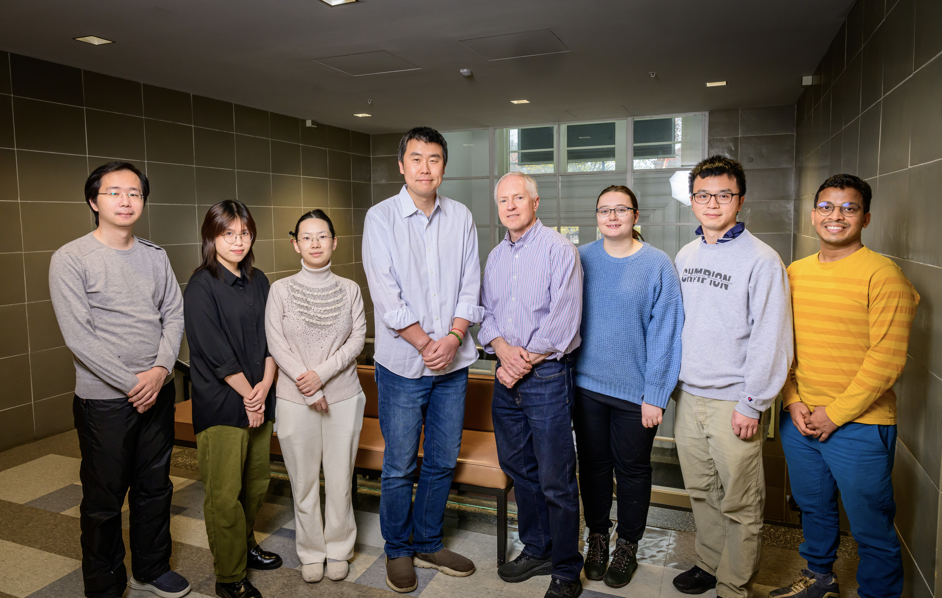 Eight members of the research team standing side by side