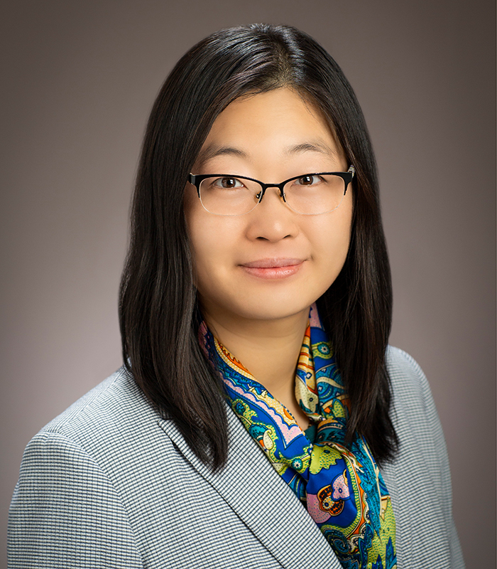 Head shot of Ying Diao on a tan background