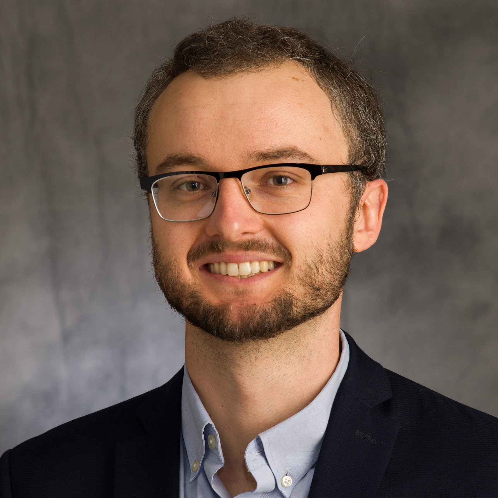 Head shot of Nick Jackson on a dark grey background