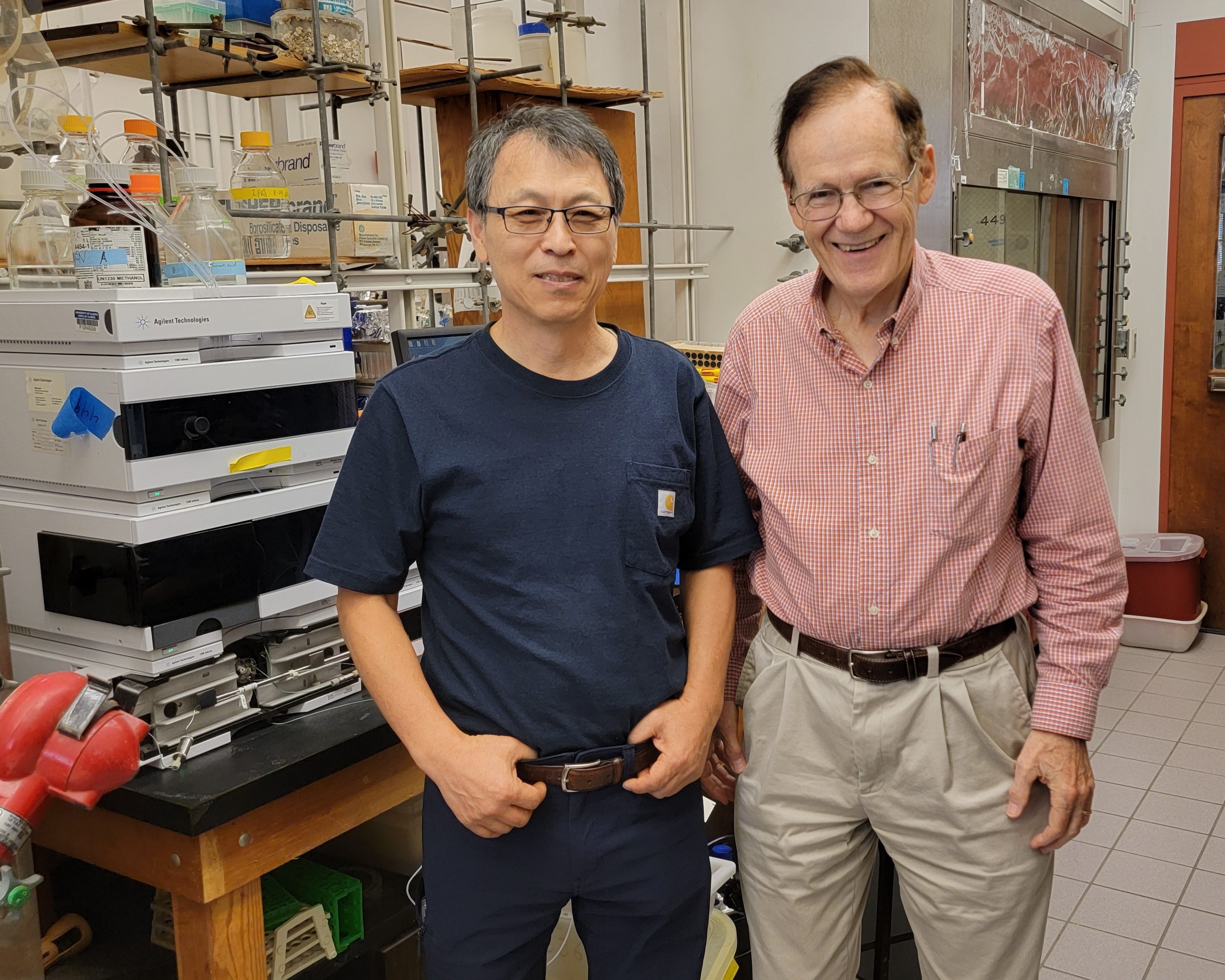 Two people standing side by side in a chemistry lab