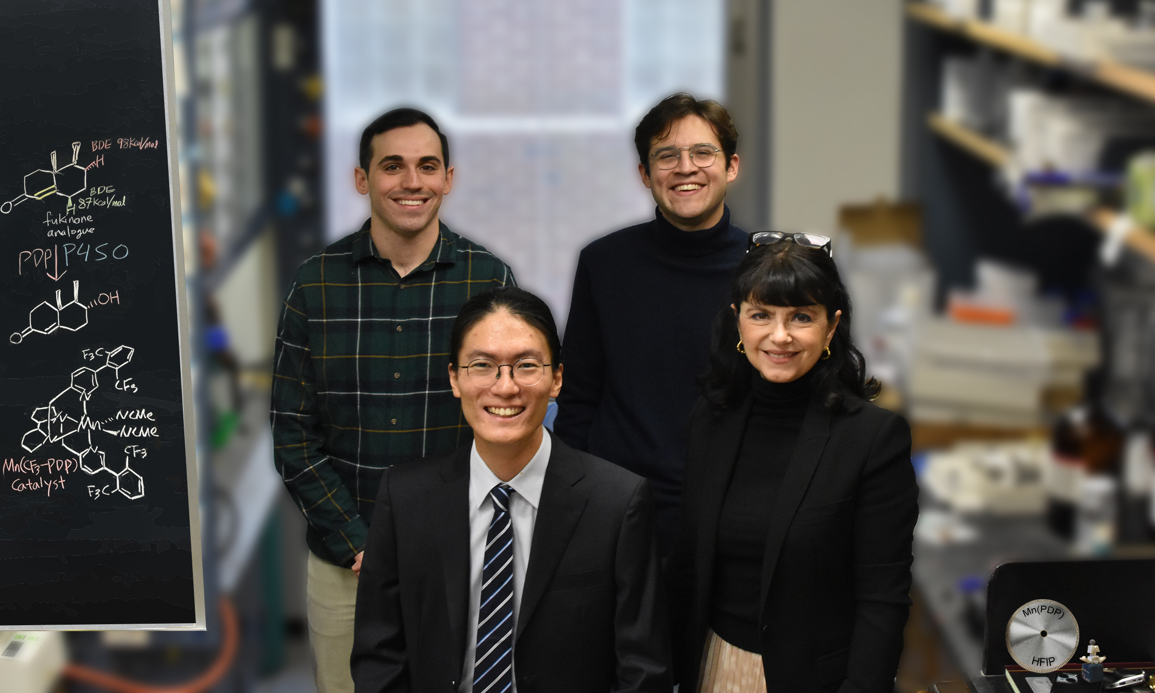 Four people standing together in a research lab