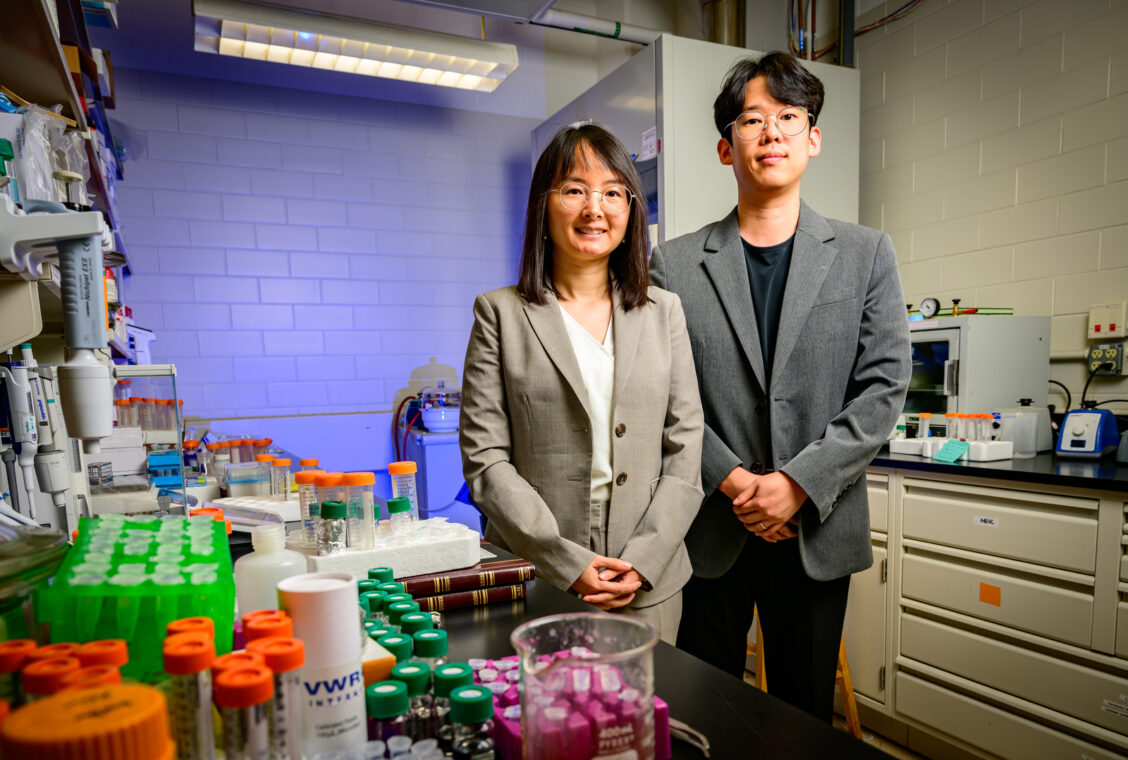 Two researchers standing together in a lab