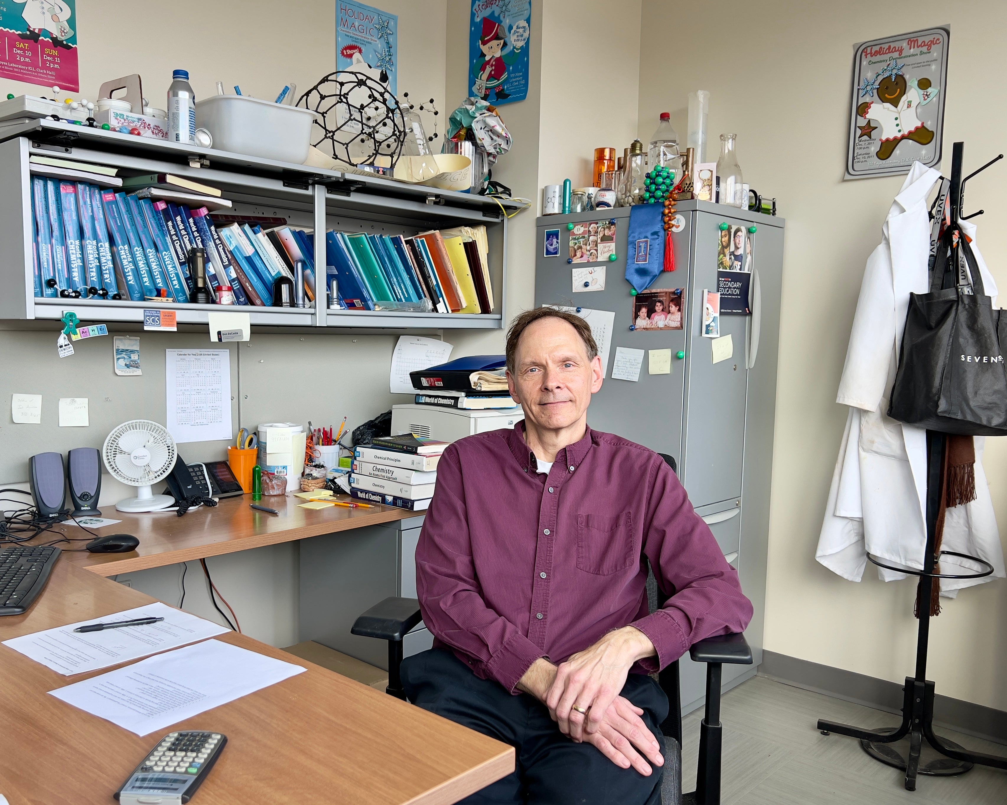 Don DeCoste sitting at a desk in his office