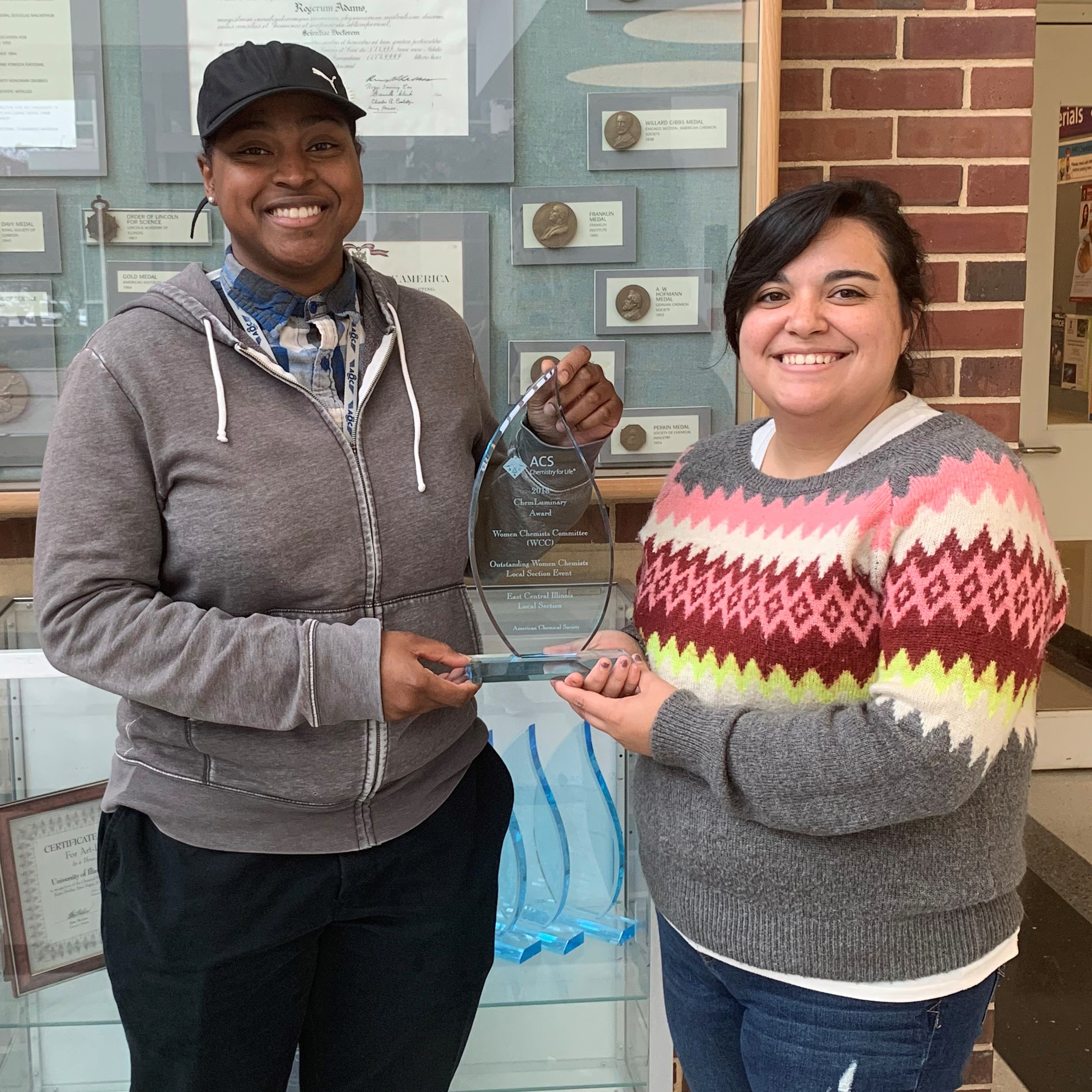 Safiyah Muhammad and Tabitha Miller, WCC board members and co-chairs for the 2018 Bonding with Chemistry day camp, pose with their award.
