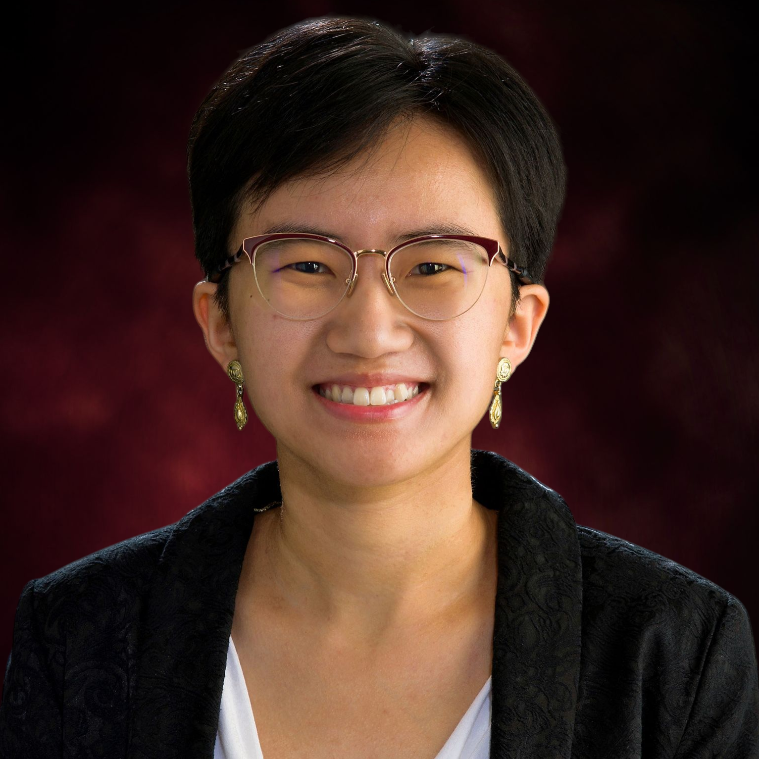 Head shot of Amanda Lam on a dark red/gray background.