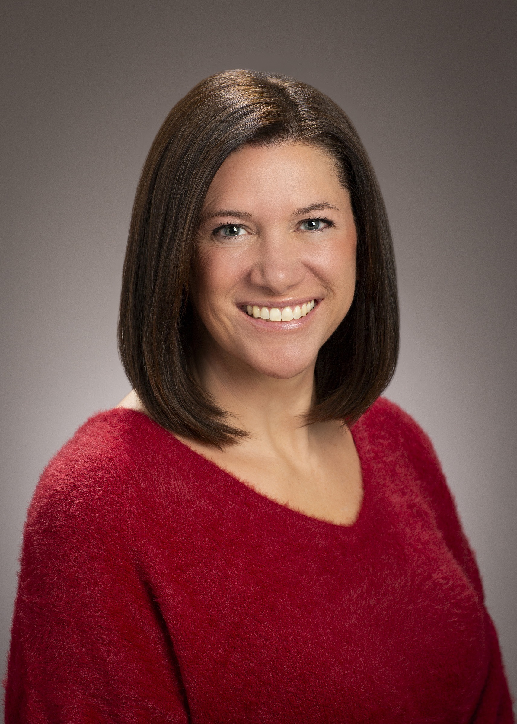 Portrait of Keely Ashman on a tan background