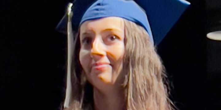 Head shot of Michelle Bishka in a graduation cap