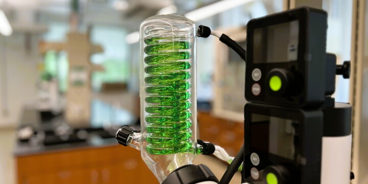 Inorganic chemistry equipment with a green spiral tube inside a glass cylinder
