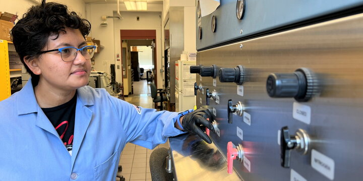 chemist looking at equipment controls
