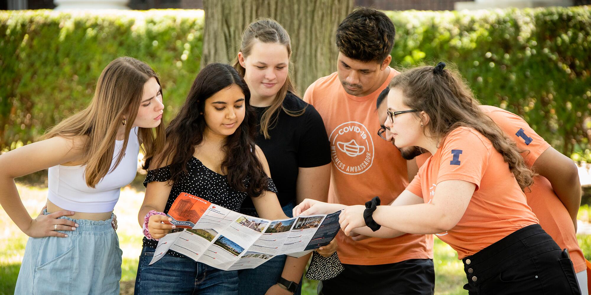 Group of students on the quad looking at a map