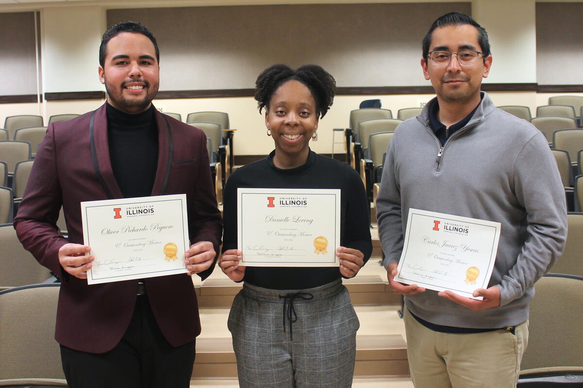 Photo of three students holding certificates