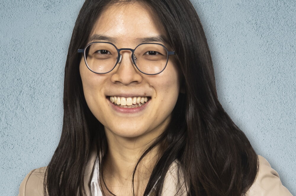 Head shot of Hee-Sun Han, blue background