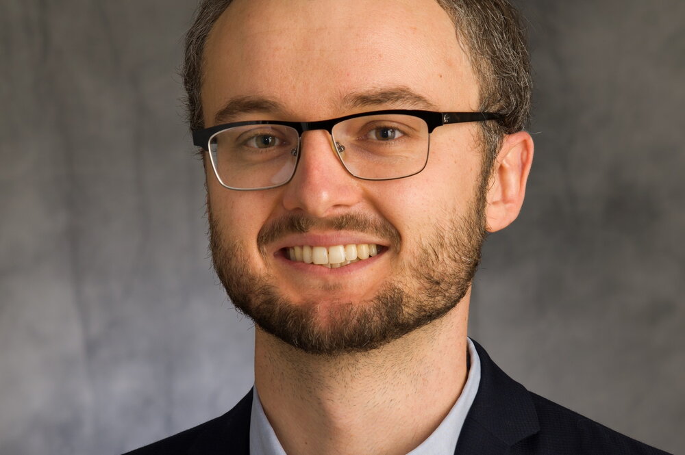 Head shot of Nick Jackson on a dark grey background