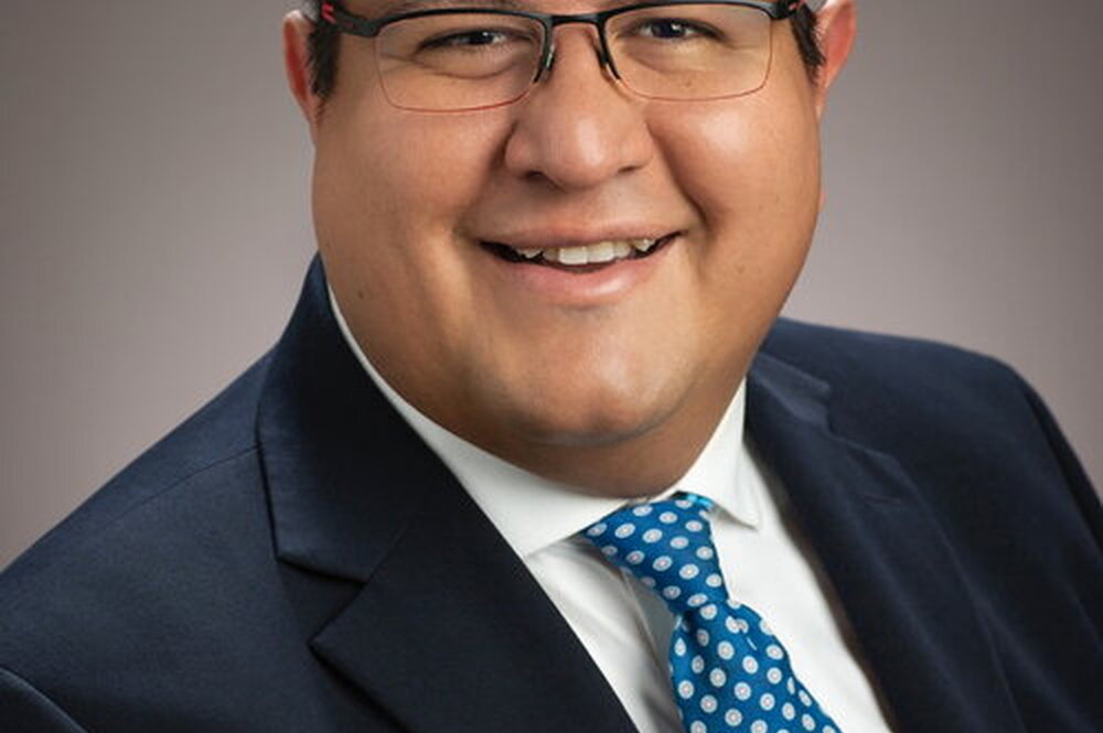 Portrait of Joaquin Rodriguez-Lopez on a tan background