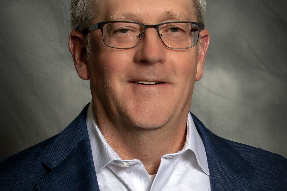 Portrait of David Hays on a gray background