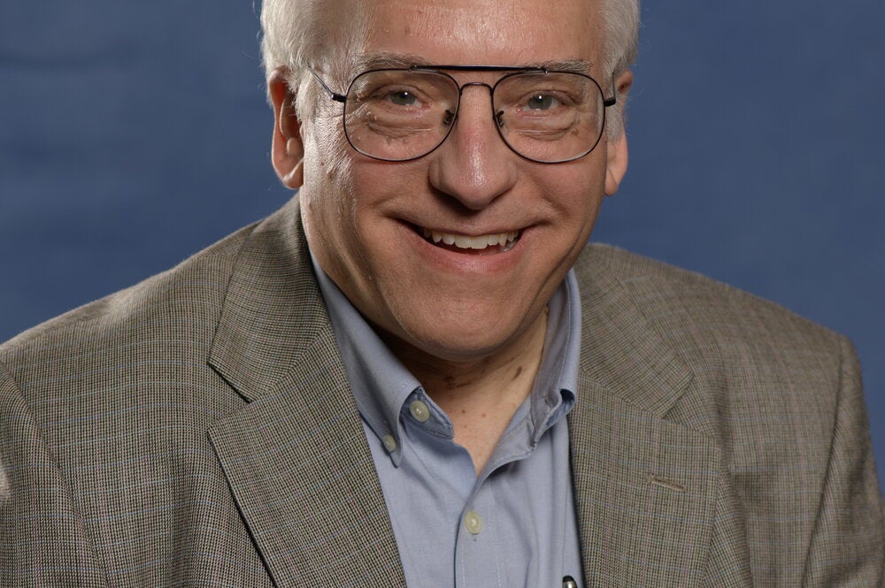 Portrait of Alexander Scheeline on a dark blue background
