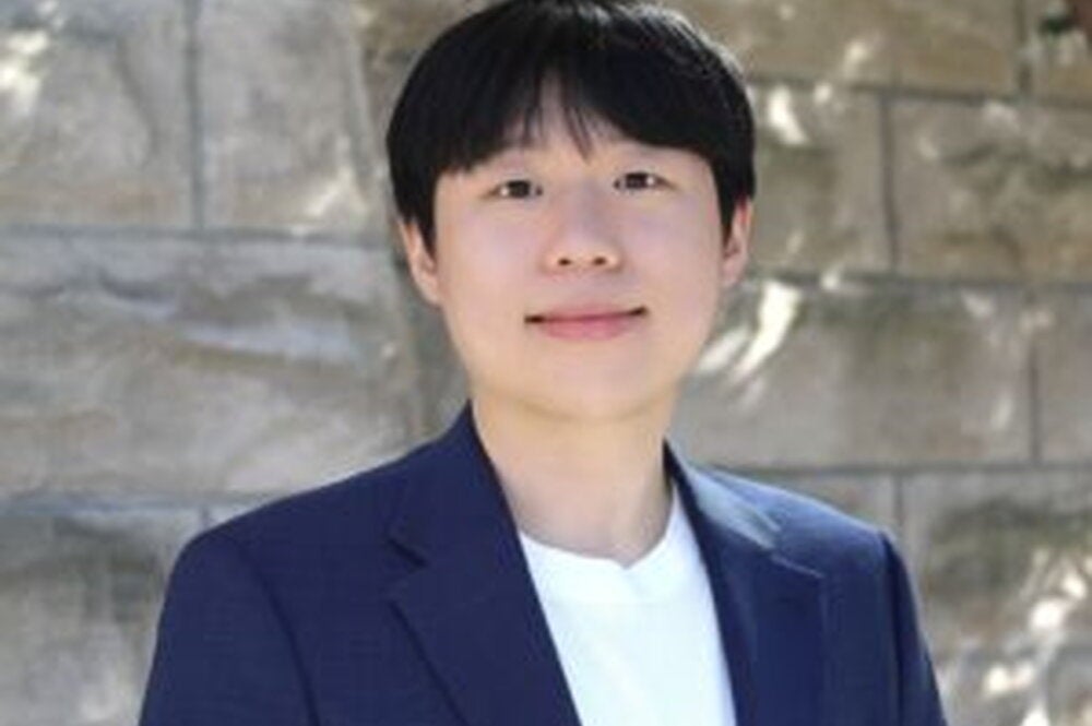 Head shot of Jusung An in front of a brick wall