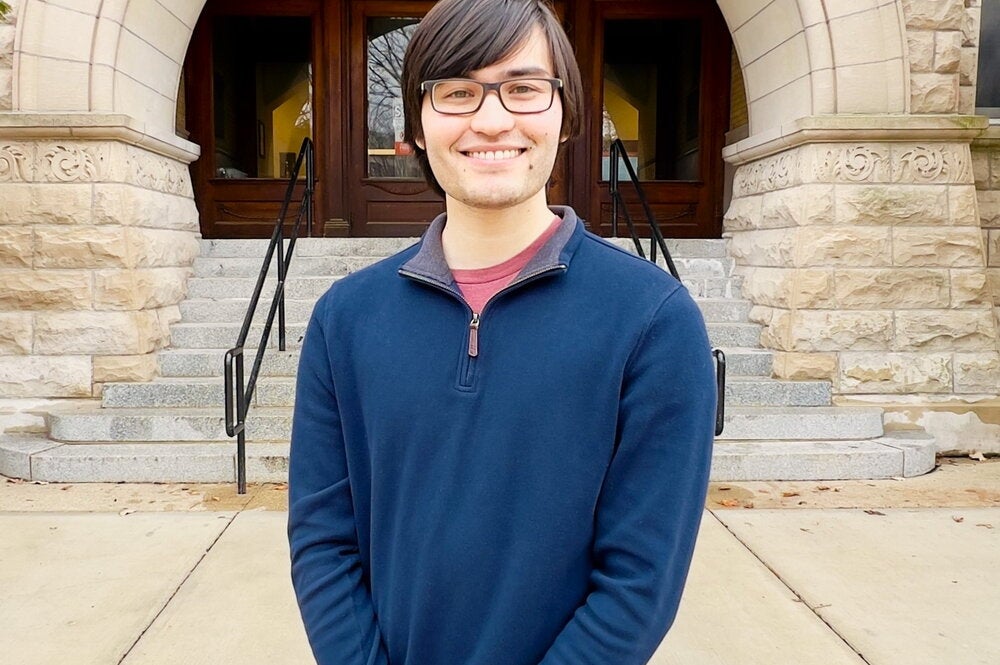 Portrait of Gavin Hazen in front of arch entrance