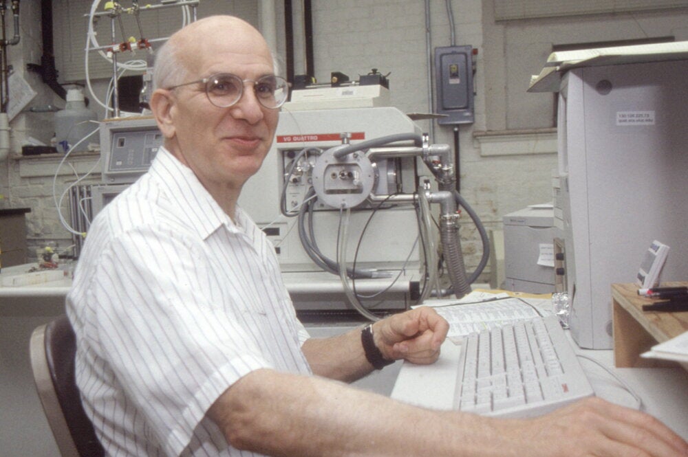 Richard Millberg sitting at a computer keyboard in a lab