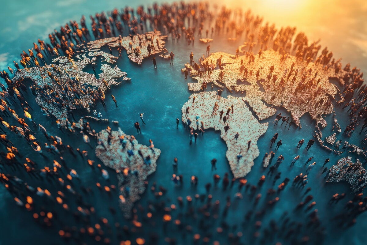 Map of the world with many people standing all over the map