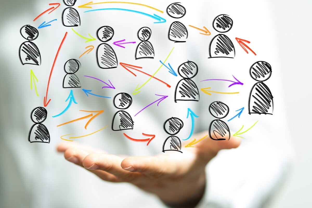 Hand appearing to hold figures of people connected by arrows