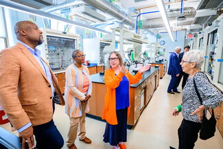 People walking around looking at a new chemistry instructional lab