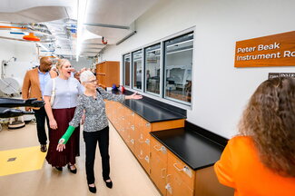 People walking through a lab on a tour.