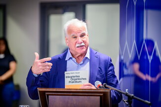 Scott Denmark speaks at a podium