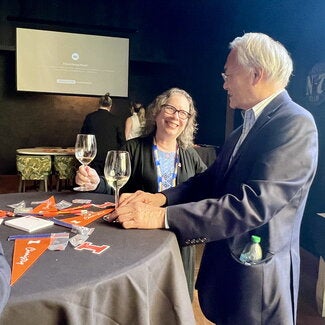 Two guests visiting at a reception table