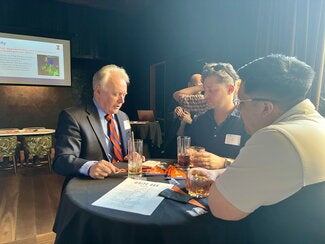 Three guests at a high-top table.