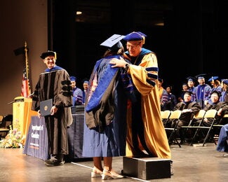 Graduate hugging a professor