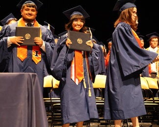 Graduate holding diploma